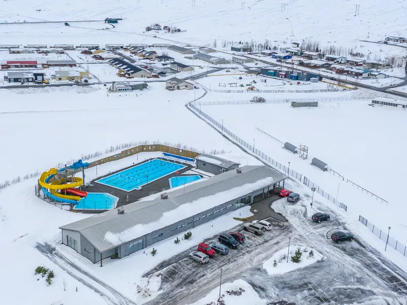 Eskifjörður swimming pool and town under snow, seen from above